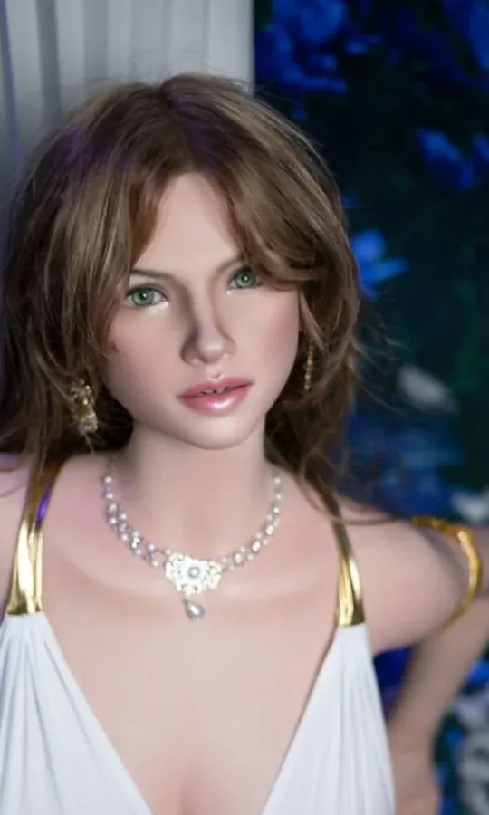Doll with wavy light brown hair in a white and gold dress
